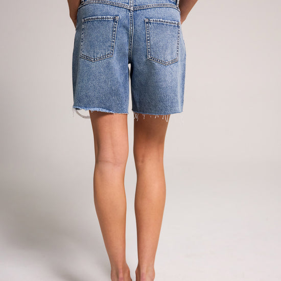 Belle's Baggy Bermuda Short - Medium Indigo, crafted from 100% cotton, features a relaxed fit and stylish design.