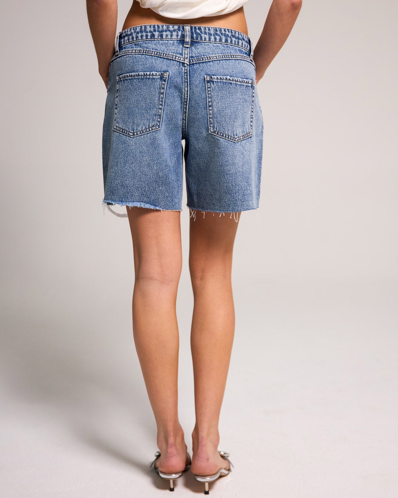 Belle's Baggy Bermuda Short - Medium Indigo, crafted from 100% cotton, features a relaxed fit and stylish design.