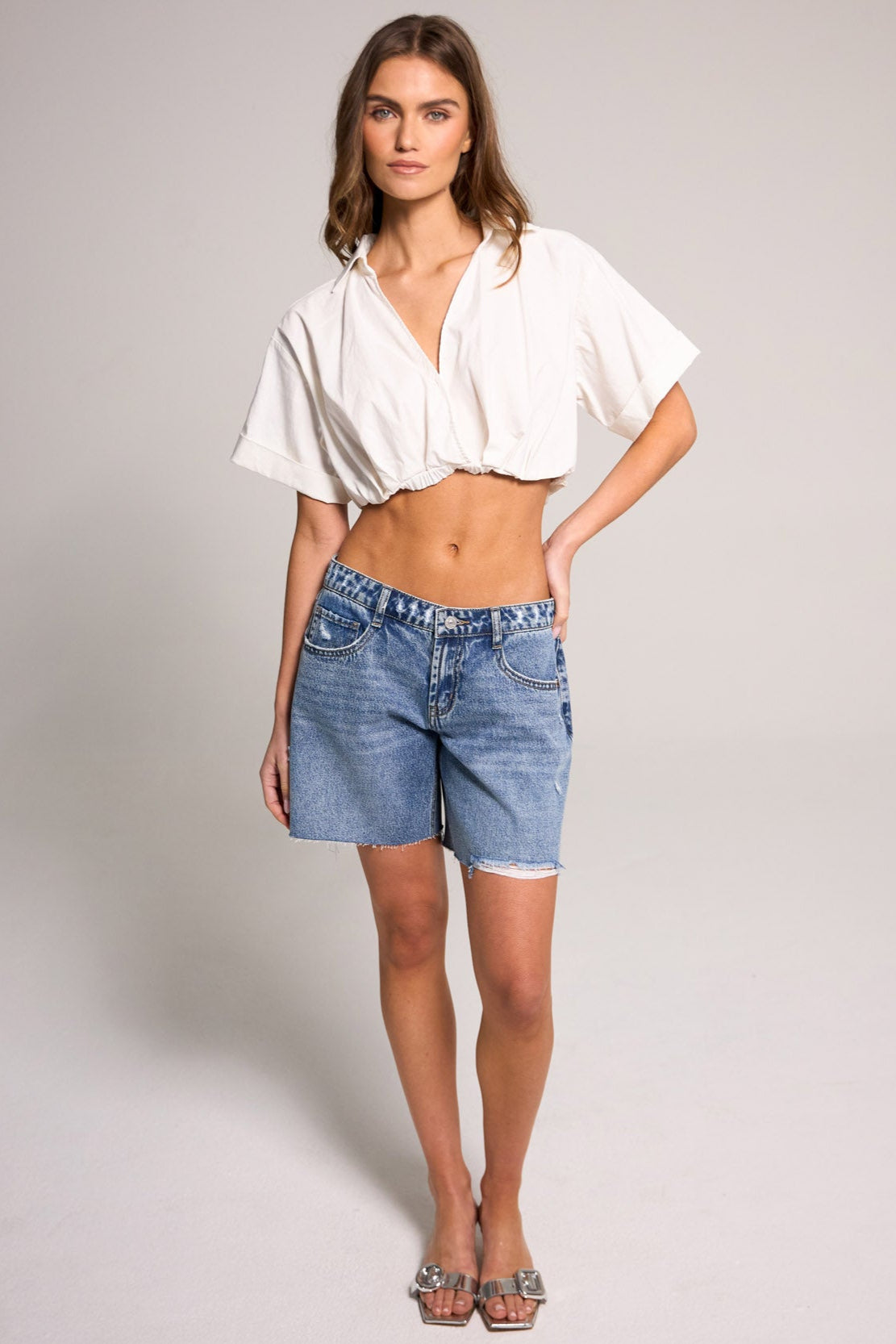 Stylish model showcasing Belle's Baggy Bermuda Short - Medium Indigo, made of 100% cotton for effortless summer wear.