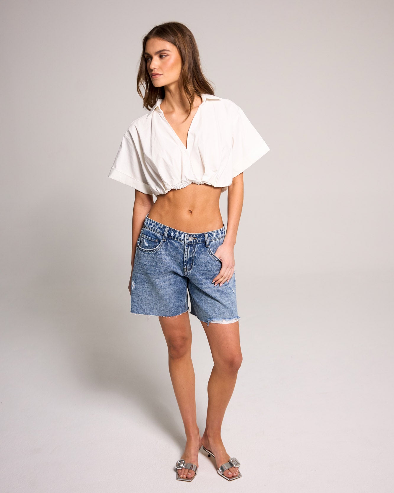 Stylish model showcasing Belle's Baggy Bermuda Short - Medium Indigo made of 100% cotton for a trendy look.